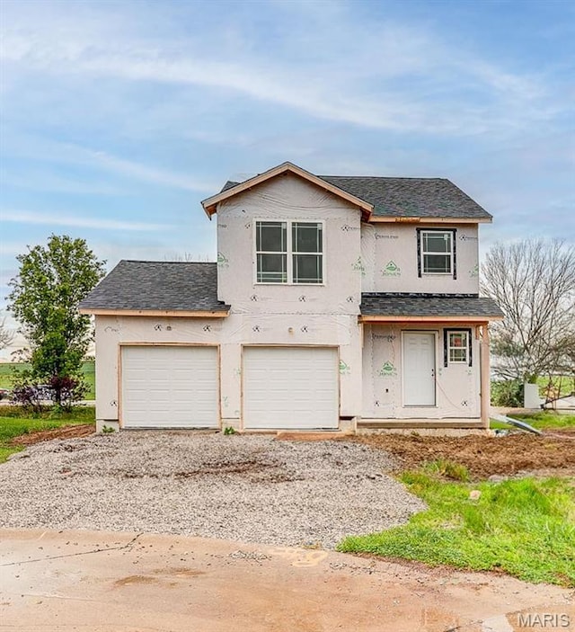 1404 Orchard Lakes Cir, Belleville, IL 62220 - unfinished property with driveway, stucco siding, a shingled roof, and a garage