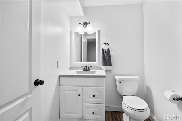 6 Bradley Ct, Troy, IL 62294 - bathroom with vanity, baseboards, toilet, and wood finished floors