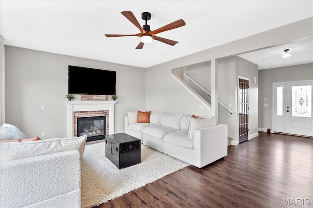 6 Bradley Ct, Troy, IL 62294 - living room with ceiling fan, dark wood-style flooring, stairs, a fireplace, and baseboards
