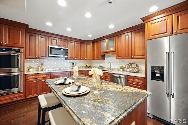 585 Coeur De Royale Dr Unit 203, Creve Coeur, MO 63141 - kitchen with appliances with stainless steel finishes, decorative backsplash, light stone countertops, and recessed lighting