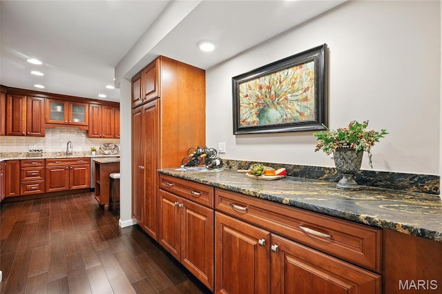 585 Coeur De Royale Dr Unit 203, Creve Coeur, MO 63141 - kitchen with recessed lighting, dark wood-type flooring, brown cabinets, tasteful backsplash, and glass insert cabinets