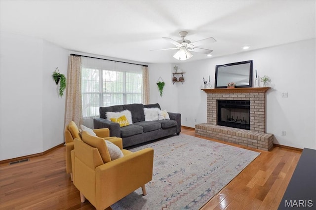 1138 Illini Dr, Ofallon, IL 62269 - living room with wood finished floors, a fireplace, baseboards, ceiling fan, and recessed lighting