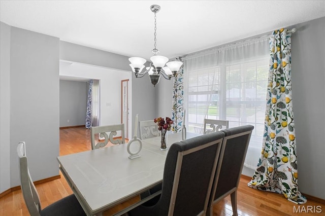 1138 Illini Dr, Ofallon, IL 62269 - dining area featuring a chandelier, light wood-style flooring, and baseboards