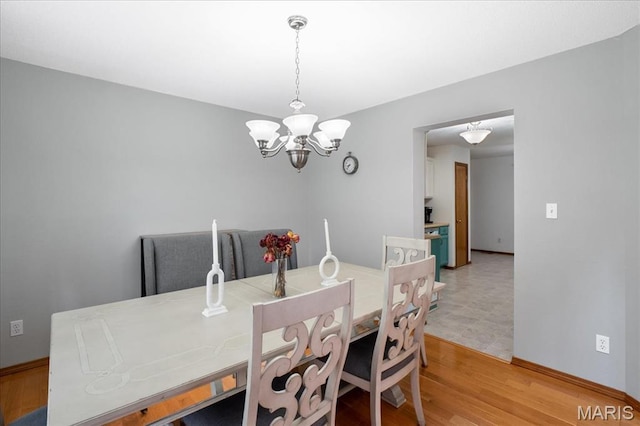 1138 Illini Dr, Ofallon, IL 62269 - dining area with a chandelier, light wood-type flooring, and baseboards