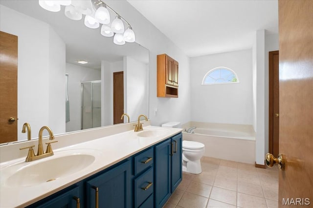1138 Illini Dr, Ofallon, IL 62269 - full bath featuring a shower stall, double vanity, a bath, tile patterned floors, and toilet