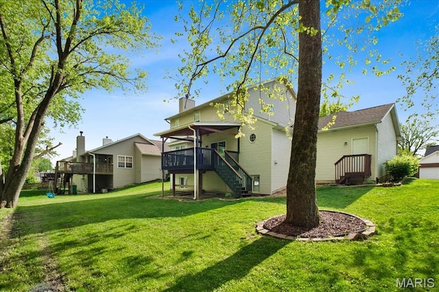 1138 Illini Dr, Ofallon, IL 62269 - rear view of property featuring stairs, a yard, a wooden deck, and a chimney