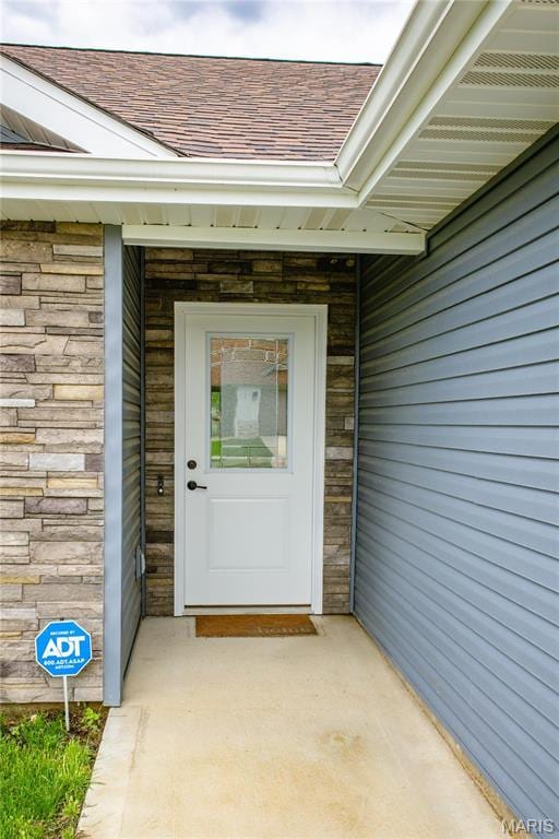 159 Mesa Dr, Waynesville, MO 65583 - property entrance with roof with shingles and stone siding
