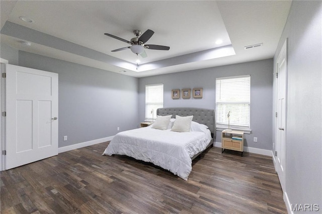 159 Mesa Dr, Waynesville, MO 65583 - bedroom with a tray ceiling, dark wood-type flooring, baseboards, and recessed lighting