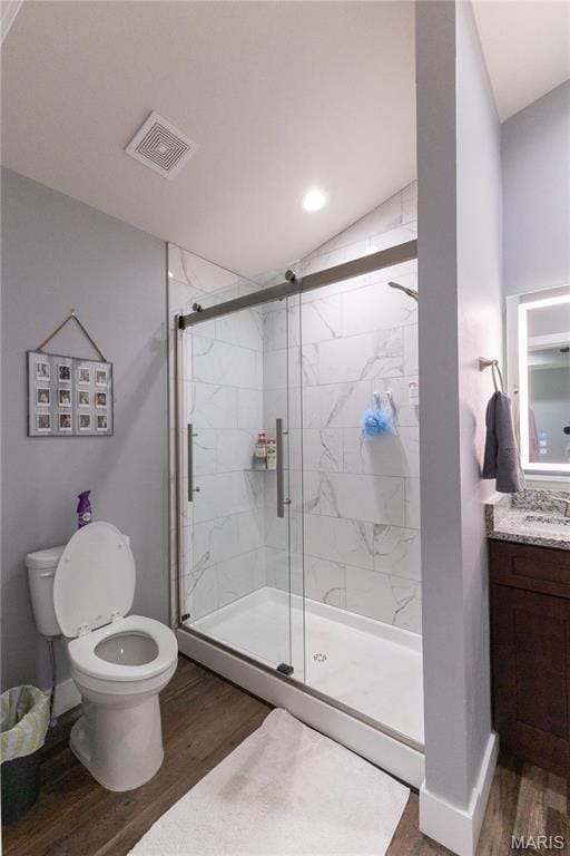 159 Mesa Dr, Waynesville, MO 65583 - bathroom featuring wood finished floors, toilet, a shower stall, and recessed lighting