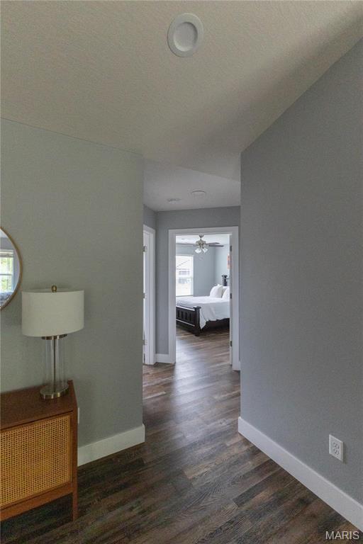 159 Mesa Dr, Waynesville, MO 65583 - corridor featuring baseboards and dark wood-style floors