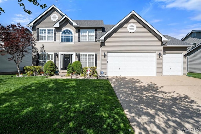 colonial inspired home featuring concrete driveway, a front lawn, and an attached garage