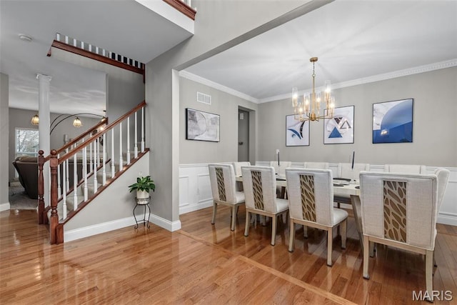 dining area with a chandelier, wood finished floors, stairway, crown molding, and baseboards