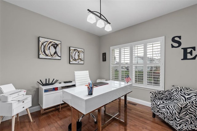 home office featuring baseboards and dark wood-type flooring
