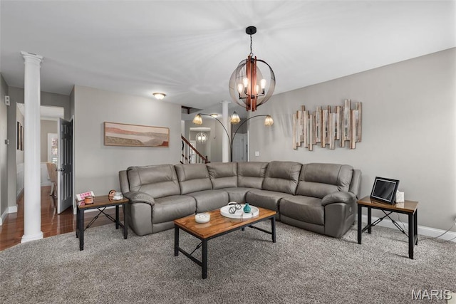living area with a chandelier, baseboards, and decorative columns