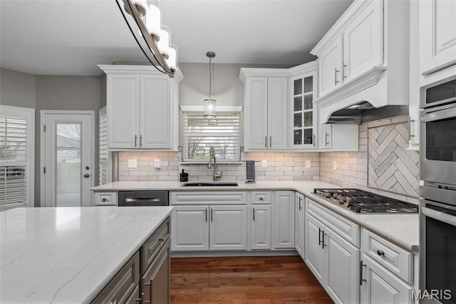 kitchen featuring a sink, stainless steel gas cooktop, and white cabinets