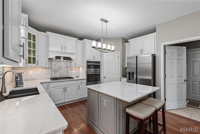 kitchen featuring appliances with stainless steel finishes, a chandelier, and white cabinets