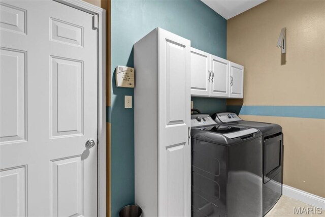 laundry room featuring independent washer and dryer and cabinet space