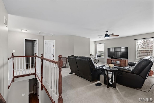 living area featuring a ceiling fan and carpet flooring