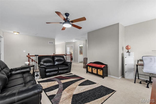 living room with light colored carpet, a ceiling fan, and baseboards