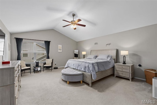 bedroom featuring vaulted ceiling, light colored carpet, baseboards, and a ceiling fan