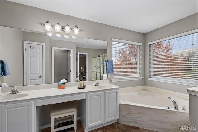 full bath featuring a shower stall, a bath, and double vanity