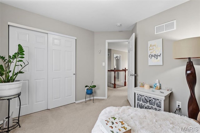 bedroom with carpet, a closet, and baseboards
