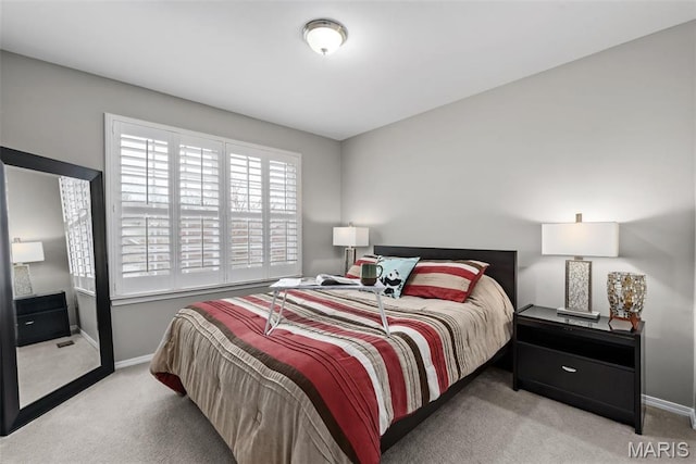 carpeted bedroom featuring baseboards