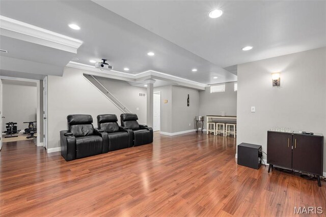 cinema room with recessed lighting, wood finished floors, ornate columns, and baseboards