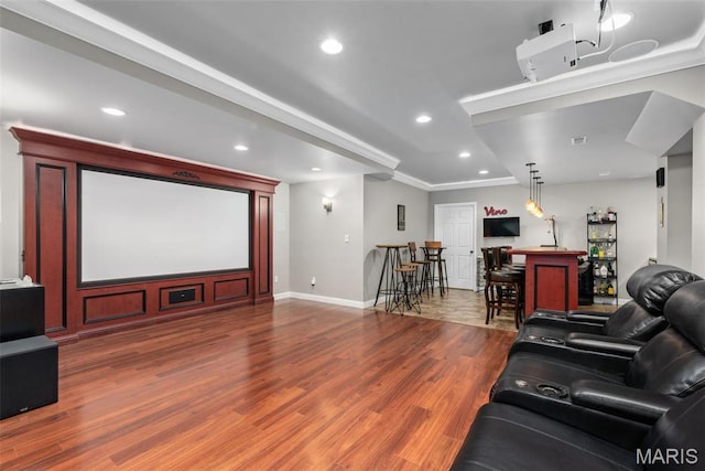 cinema with wood finished floors, baseboards, a dry bar, and recessed lighting