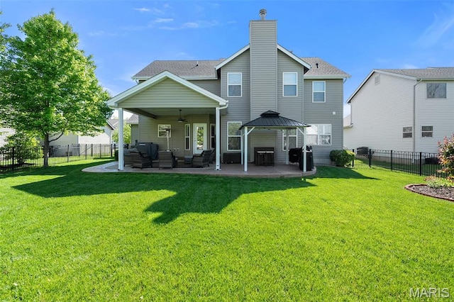 back of house with a gazebo, a patio area, a ceiling fan, an outdoor living space, and a chimney
