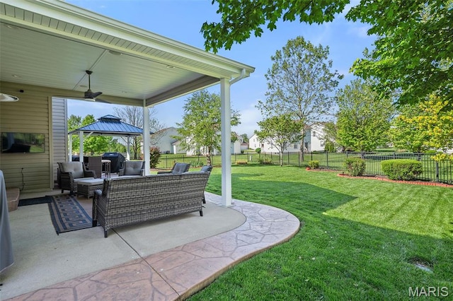 view of yard featuring ceiling fan, a gazebo, an outdoor living space, and a patio