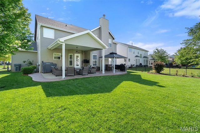 rear view of house with a chimney, an outdoor hangout area, and a patio