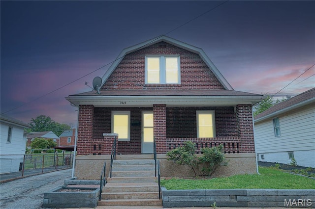 9969 Lark Ave, Saint Louis, MO 63125 - colonial inspired home featuring a porch, a gambrel roof, and brick siding