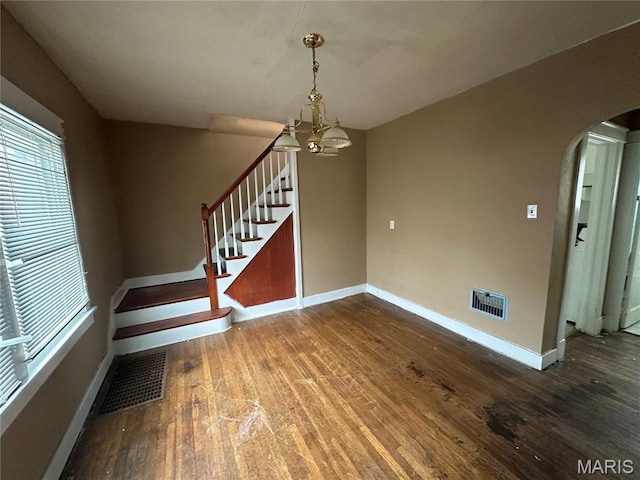 9969 Lark Ave, Saint Louis, MO 63125 - stairs featuring arched walkways, wood finished floors, and a chandelier