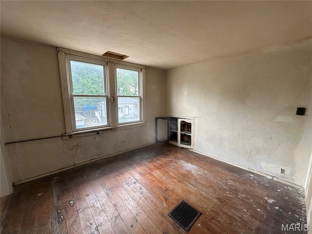 9969 Lark Ave, Saint Louis, MO 63125 - unfurnished room with wood-type flooring and a textured ceiling