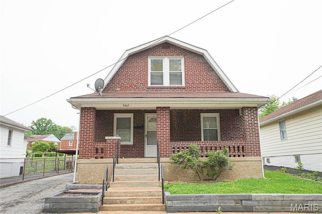 9969 Lark Ave, Saint Louis, MO 63125 - dutch colonial with a porch, a gambrel roof, and brick siding