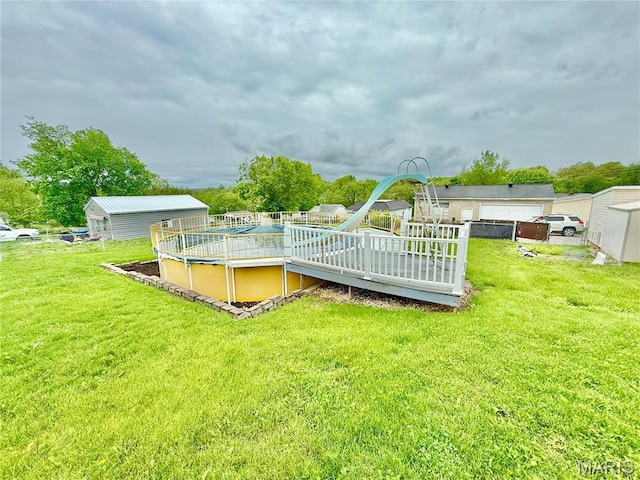 815 Stewart St, De Soto, MO 63020 - view of green lawn with an outdoor pool and a deck