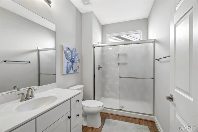 116 Dardenne Place Dr, Dardenne Prairie, MO 63368 - bathroom featuring wood finished floors, a stall shower, vanity, and toilet