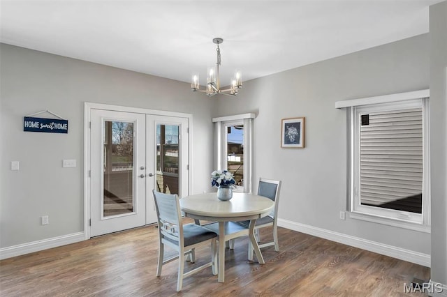 116 Dardenne Place Dr, Dardenne Prairie, MO 63368 - dining area featuring a chandelier, baseboards, wood finished floors, and french doors