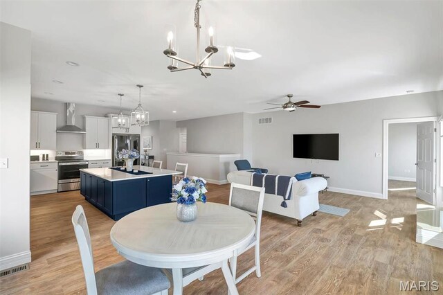116 Dardenne Place Dr, Dardenne Prairie, MO 63368 - dining room featuring a chandelier, baseboards, a ceiling fan, and light wood-style floors