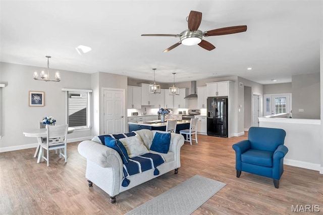 116 Dardenne Place Dr, Dardenne Prairie, MO 63368 - living area with baseboards, a ceiling fan, light wood finished floors, a chandelier, and recessed lighting