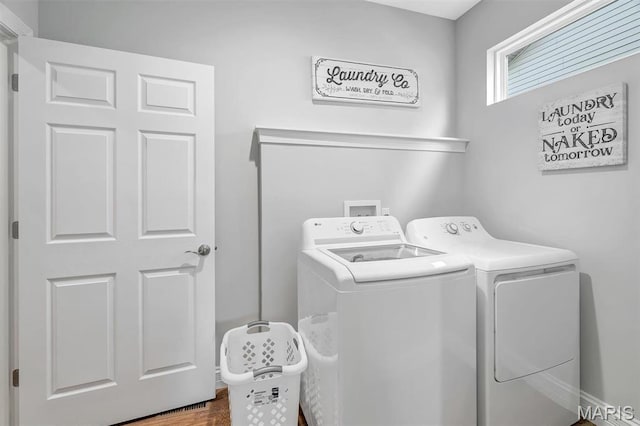 116 Dardenne Place Dr, Dardenne Prairie, MO 63368 - clothes washing area featuring washer and dryer and wood finished floors