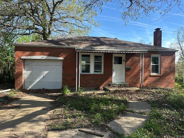 357 Fork Dr, Saint Louis, MO 63137 - ranch-style house with brick siding, a chimney, a garage, and driveway