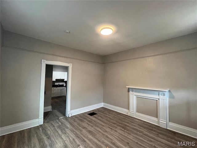 8423 Tennessee Ave, Saint Louis, MO 63125 - unfurnished bedroom featuring dark wood finished floors and baseboards