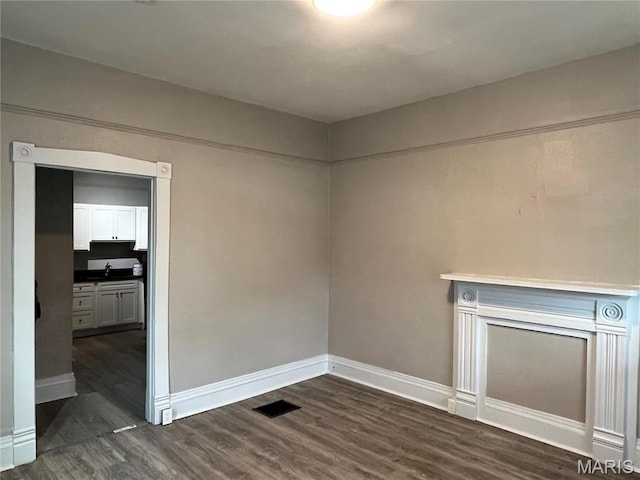 8423 Tennessee Ave, Saint Louis, MO 63125 - empty room featuring baseboards and dark wood-style flooring