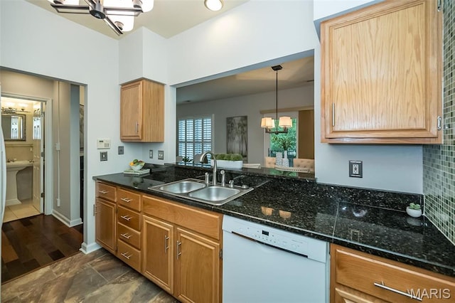 1040 Carroll St Unit 6, Saint Louis, MO 63104 - kitchen featuring white dishwasher, a sink, hanging light fixtures, a chandelier, and dark stone counters
