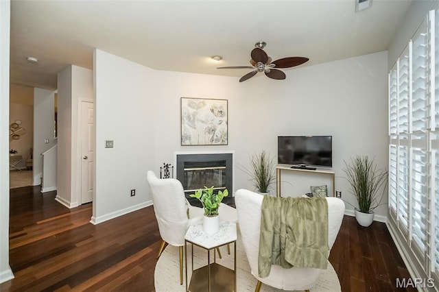 1040 Carroll St Unit 6, Saint Louis, MO 63104 - living area featuring a ceiling fan, wood finished floors, baseboards, and a glass covered fireplace