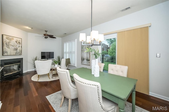 1040 Carroll St Unit 6, Saint Louis, MO 63104 - dining space featuring a chandelier, wood finished floors, baseboards, and a fireplace with flush hearth
