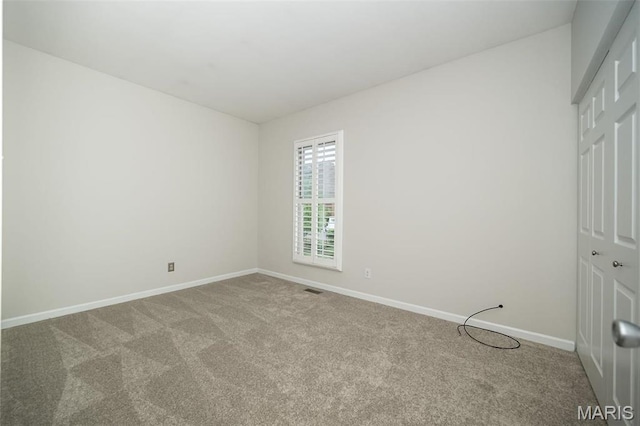 1040 Carroll St Unit 6, Saint Louis, MO 63104 - carpeted empty room with baseboards