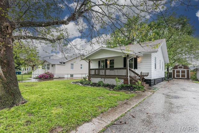 514 Hamilton Ave, Wood River, IL 62095 - bungalow-style house with covered porch, a shed, an outbuilding, and a chimney